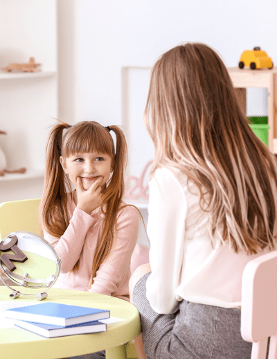 Child with adult in a classroom setting.