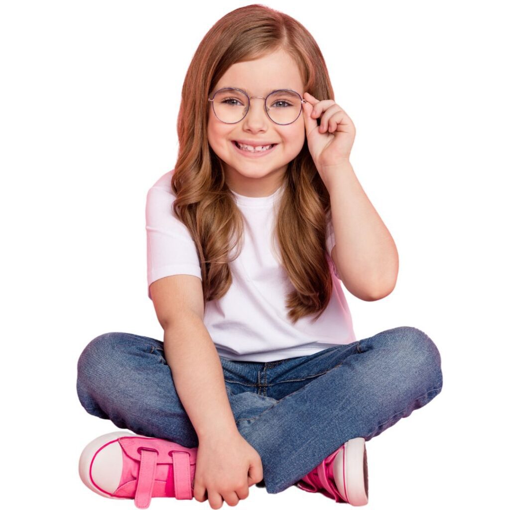 Smiling girl with glasses sitting cross-legged.